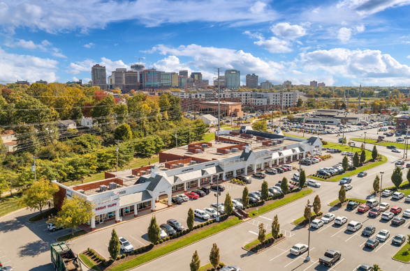 Retail shopping center in St. Louis with parking lot and surrounding commercial development